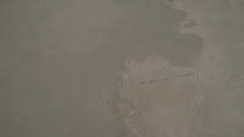 The process of priming the floor with a solution. Waterproofing a concrete floor Stock Photos