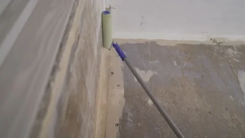 The process of priming the wall with a roller. Priming the walls in the Stock Footage 158365041