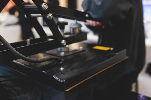 Process of printing image on clothes, heat press machine printing custom de.. Stock Photos