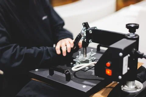 Process of printing image on clothes, heat press machine printing custom de.. Stock Photos