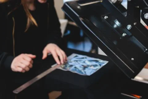 Process of printing image on clothes, heat press machine printing custom de.. Stock Photos