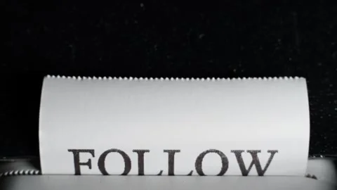 The process of printing the phrase FOLLOW YOUR HEART on white paper Stock Footage 309544984