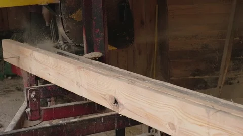 The process of processing and sawing wood at an old sawmill. Sawing and Stock Footage 209247796