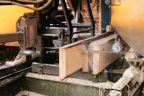 The process of processing boards at the sawmill, close-up. Stock Photos