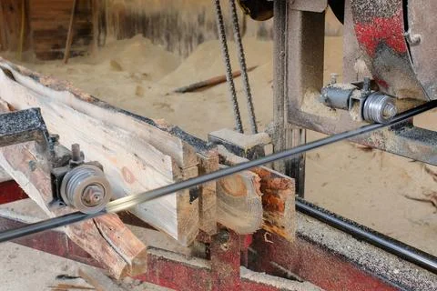 The process of processing boards on sawmill equipment. Stock Photos