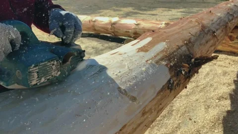 The process of processing logs from the bark with a grinding hand tool. Stock-Footage 221146901