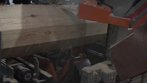 The process of processing logs on sawmill equipment. Sawing logs at sawmill equi Stock Footage 120872376