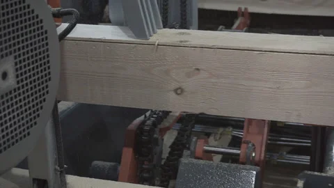The process of processing logs in sawmill equipment. Sawing logs at sawmill equi Stock Footage 121969044