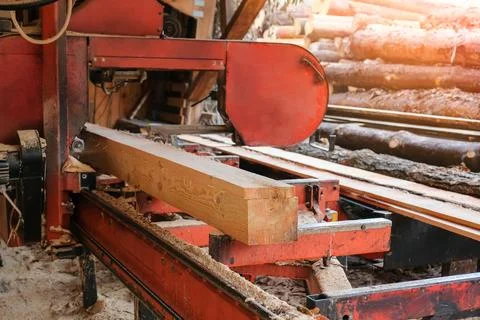 The process of processing pine wood at a sawmill. Timber industry Stock Photos