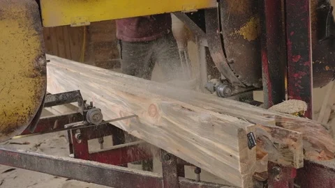 The process of processing wooden boards on an old sawmill. Woodworking industry Stock Footage 168354134