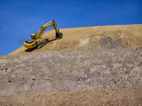 Process of profiling slopes and platforms in a leaching pad using heavy mac.. Stock Photos