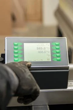 The process of programming a CNC machine. Entering data into a computer contr Stock Photos