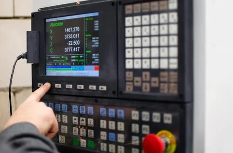 The process of programming a CNC machine. Entering data into a computer contr Stock Photos