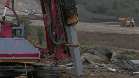 The process of pushing weights of piles into the ground Stock Footage 123586373
