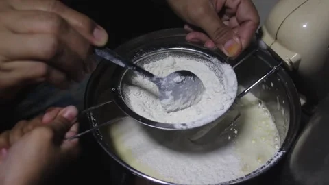 The process of putting flour into the cake dough Stock Footage 272286198
