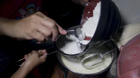 The process of putting flour into the cake dough Stock Footage 272286247