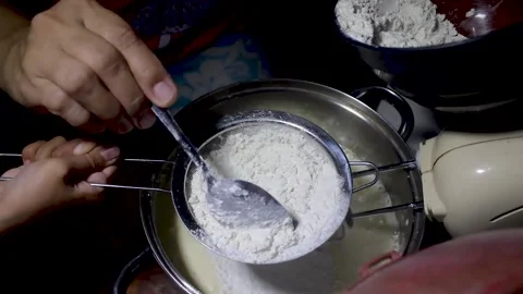 The process of putting flour into the cake dough Stock Footage 272286456