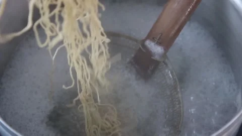 The process of putting noodles into boiling water Stock Footage 270347732