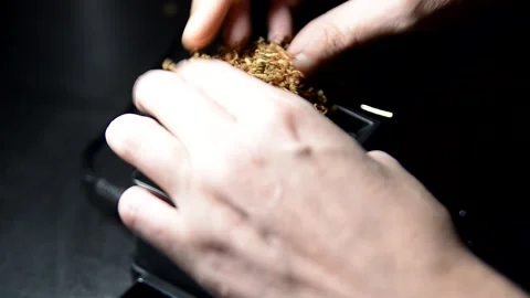 The process of putting tobacco into cigarette cases with a semi-automatic Stock Footage 223882220