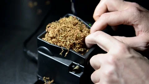 The process of putting tobacco into cigarette cases with a semi-automatic Stock Footage 223882455