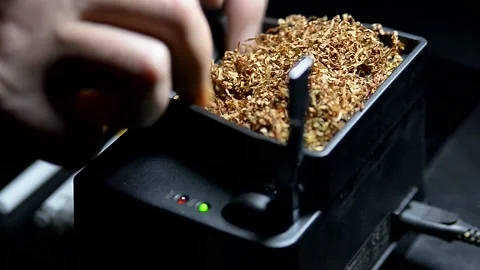 The process of putting tobacco into cigarette cases with a semi-automatic Stock Footage 223887704