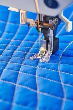 Process quilting with an electric sewing machine by using a free-motion techn Stock Photos