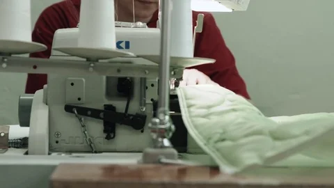 Process of quilting on patchwork blanket close up sewing machine hands Stock Footage 85287029