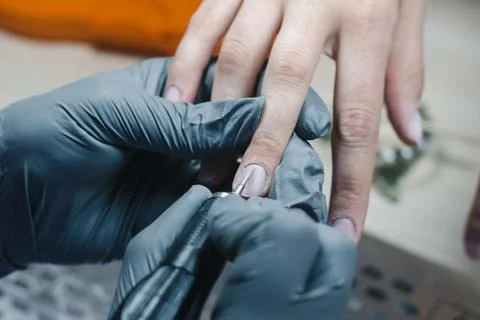 The process of removing the cuticle from the client's nail with hardware meth Foto stock