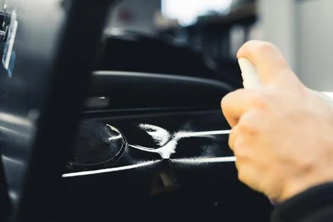 Process of removing small dents and damages from a black car at mechanic's Stock Photos