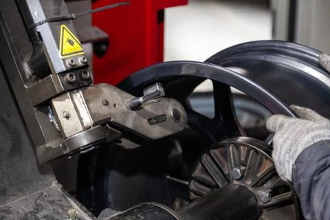 The process of repairing an automobile wheel using a special press on a machi Stock Photos