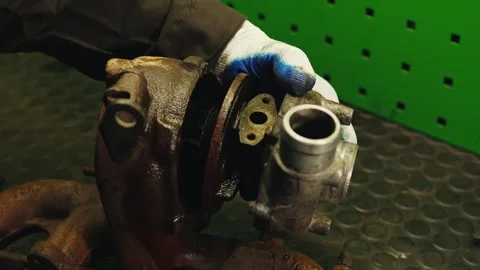 Process of repairing an old rusty automobile turbine, disassembling the turbine, Stock Footage 284545354