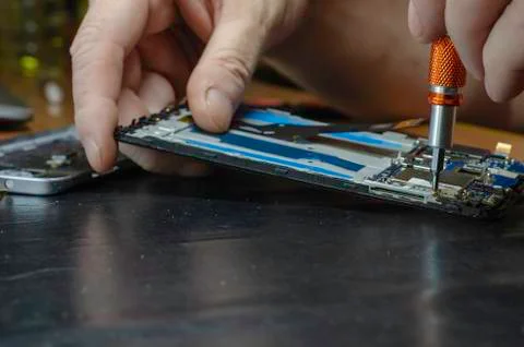 Process of repairing a smartphone in specialized workshop. Stock Photos