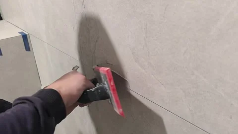 The process of repairing a wall tile in the comfort of a home environment, parti Stock Footage 343387428