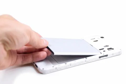 The process of replacing the battery in a cell phone. Stock Photos