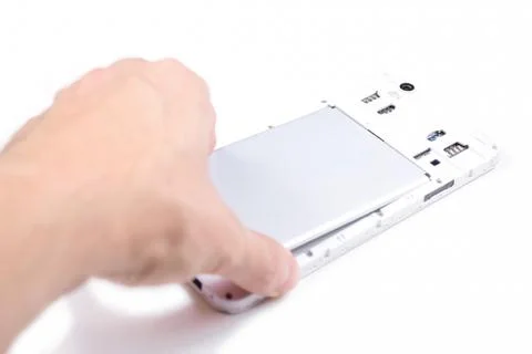 The process of replacing the battery in a cell phone. Stock Photos
