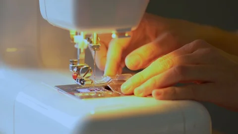 The process of replacing a bobbin in a shuttle device of a sewing machine. Close Stock Footage 128795420