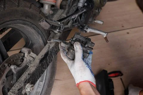 The process of replacing brake pads on a motorcycle. Stock Photos