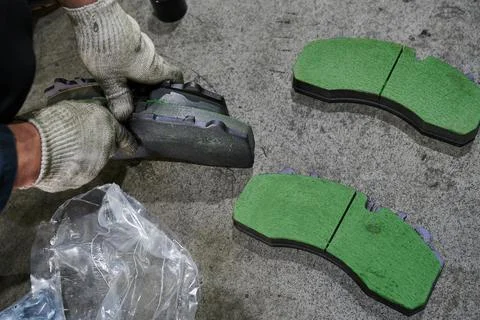 The process of replacing brake pads on a regular bus in a workshop Stock Photos