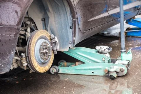 The process of replacing summer tires with winter tires. Stock Photos