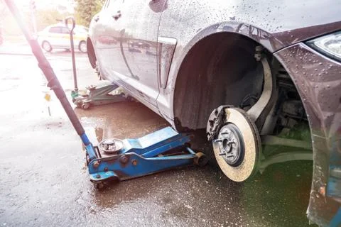 The process of replacing summer tires with winter tires. Stock Photos