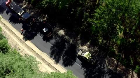 The Process Of Road Constructing Two Road Rollers And A Truck Driving Stock Footage 142000818