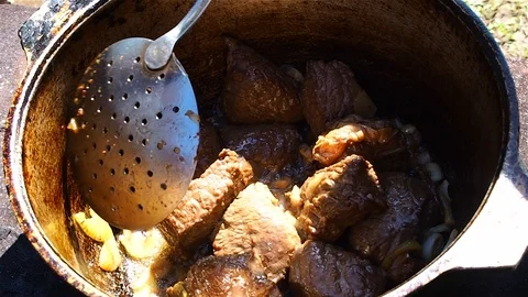 The process of roasting beef in a cast iron pot Stock Footage 109438983