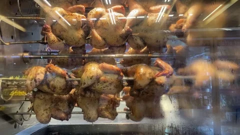 The process of roasting chicken in a roasting machine Stock Footage 221999296