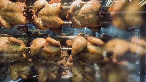 The process of roasting chicken in a roasting machine Stock Footage 221999302