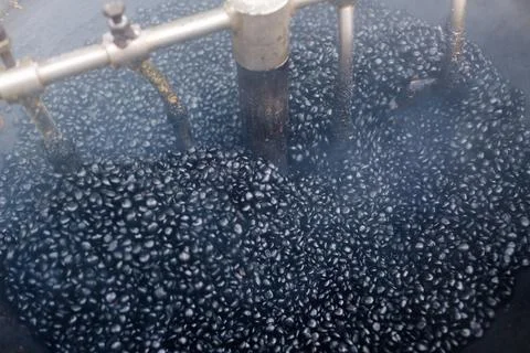 The process of roasting coffee in a traditional installation using dark roast Stock-Fotos