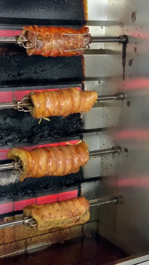 Process of roasting pork belly using a modern rotary rotisserie oven Stock Footage 347542410