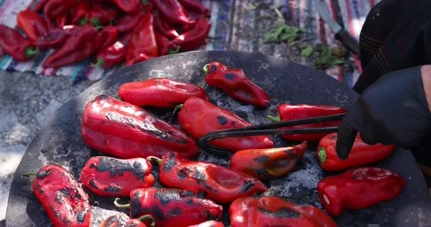 Process of roasting red pepper during preparation of ajvar. Flipping the peppers Stock Footage 207720936