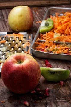 Process of rubbing fragrant ripe fruit and carrots fruit salad Stock Photos