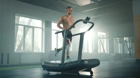 Process of running on treadmill in gym by young handsome fit sportsman Stock Footage 240325504
