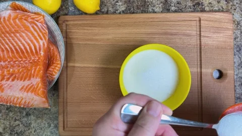 The process of salting salmon fillets. Preparing a mixture of salt and sugar Stock Footage 300461400